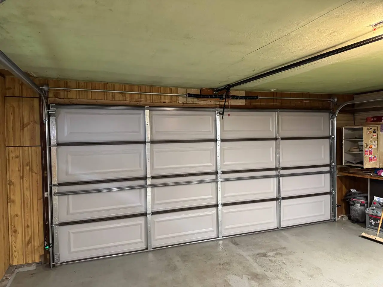 Inside view of the new door with the torsion spring above the opening